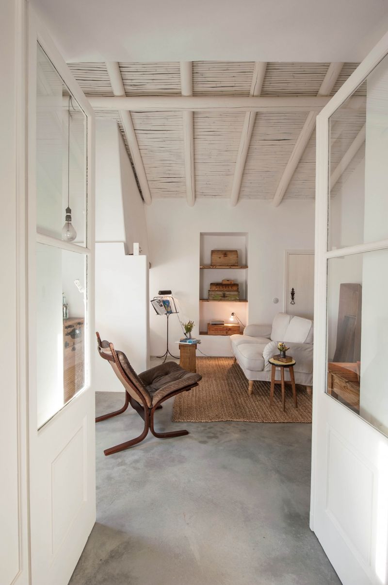 Pensão Agrícola, Tavira, Algarve: whitewashed sitting room with cane ceiling and vintage furniture on a 1920 farm, restored by Atelier RUA.