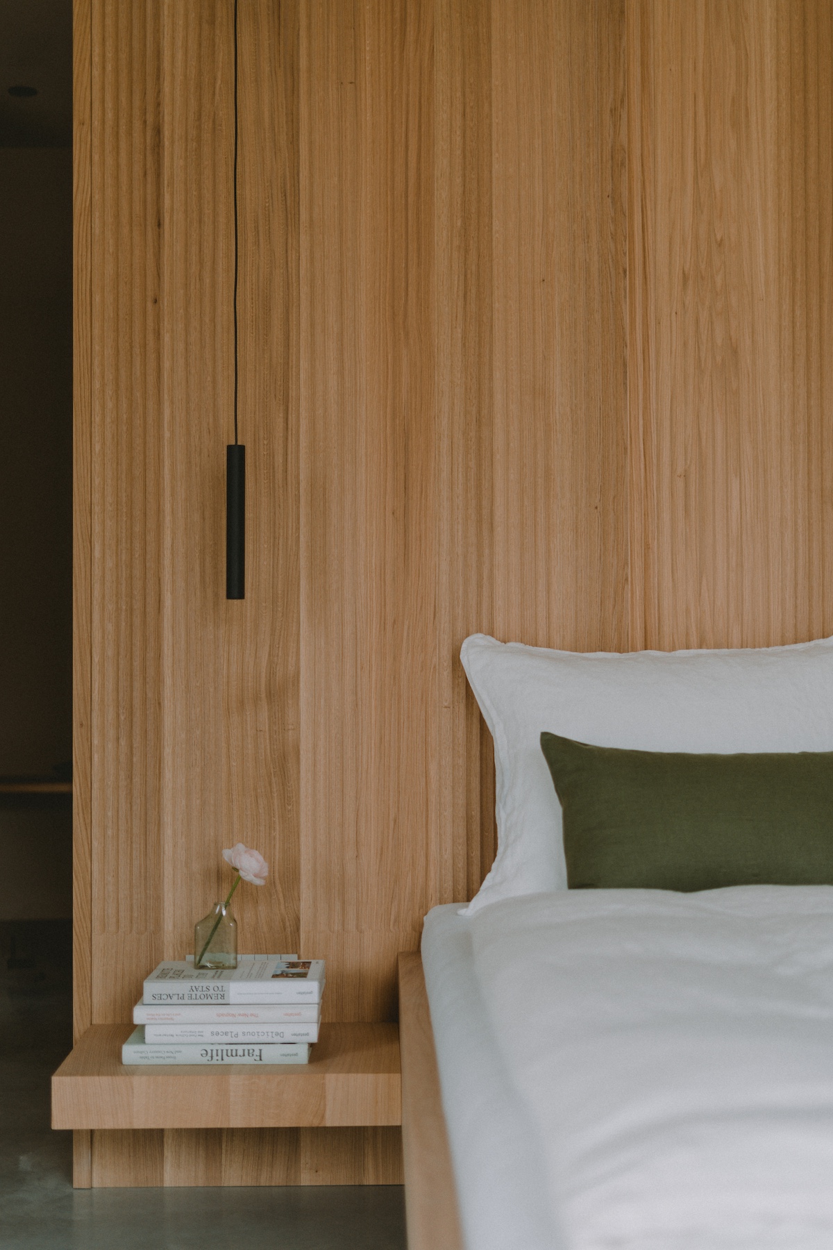 Beautifully panelled timber headboard wall behind the bed with a single pendant light | Design Hotel Corte Pravecchi 