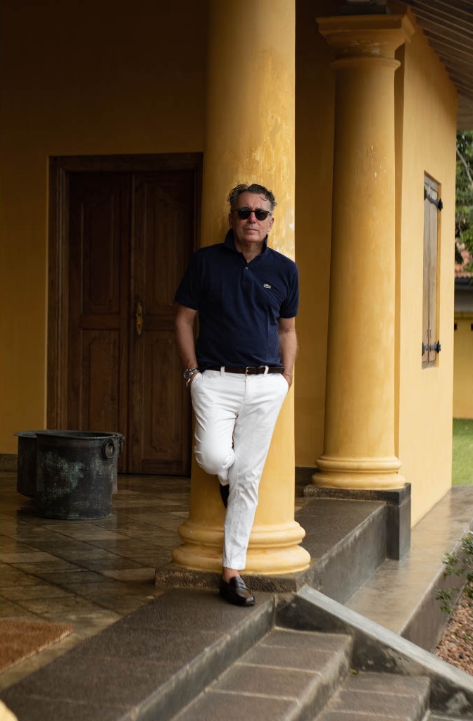 Peter Harris | Man standing on the golden coloiured porch in Sri Lanka at the Doornberg House guesthouse Gale | Manmade: 12 Hotels Shaped by Men of Design and Style