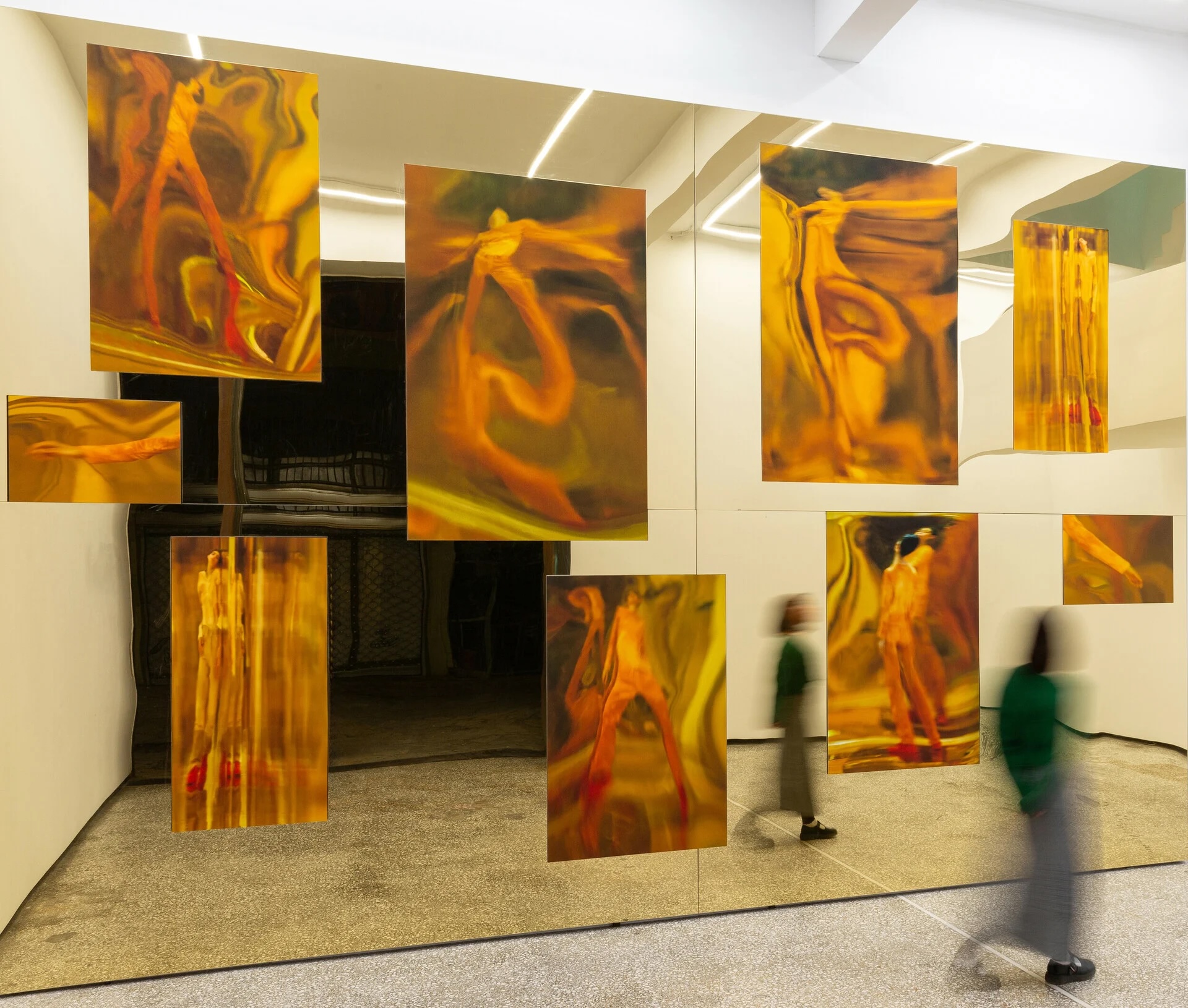 Visitors passing a wall of gold mirrored photographic panels at The Breeder, Metaxourgeio, Athens | The Aficionados