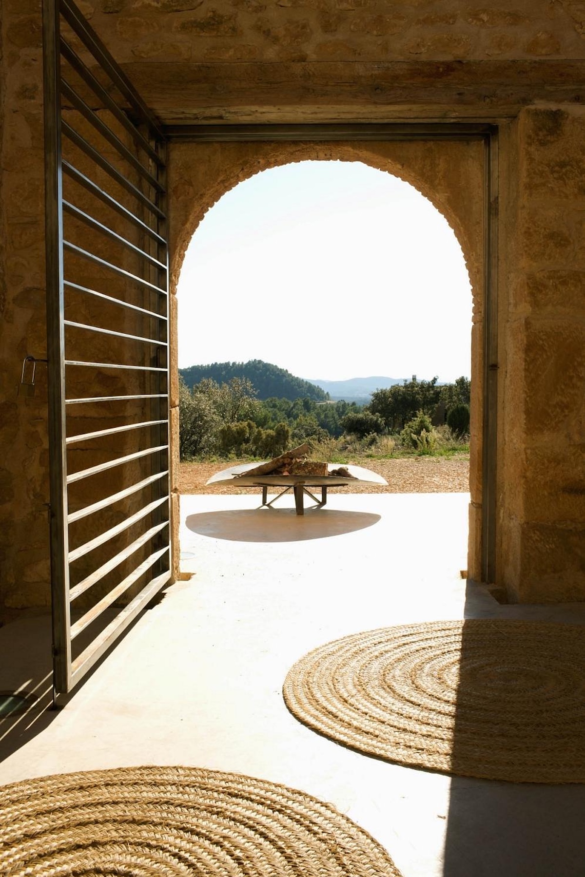 View through a Moorish stone arch at Consolación to the hillside hearth and the Matarranya beyond | The Aficionados