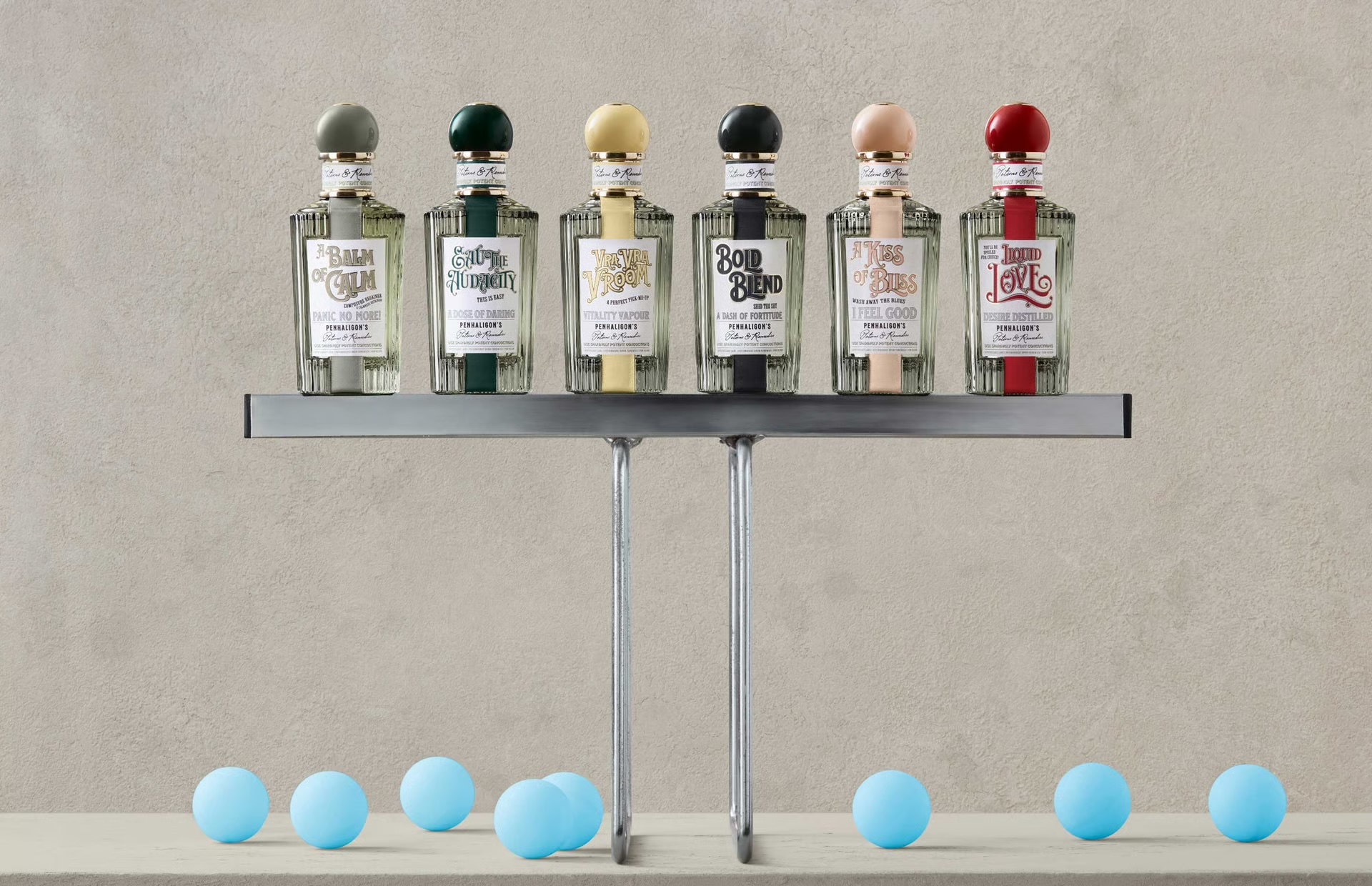 Penhaligon's Potions & Remedies collection: six ribbed apothecary-style bottles with coloured stoppers, including Bold Blend, on a metal stand