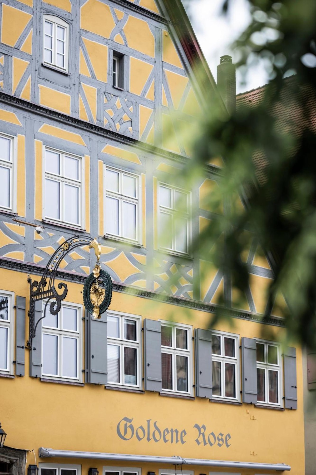 Medieval restored building painted in period historc yellow | Goldene Rose Dinkelsbühl by NOA | Rooftop Spa and Heritage Hotel Restoration