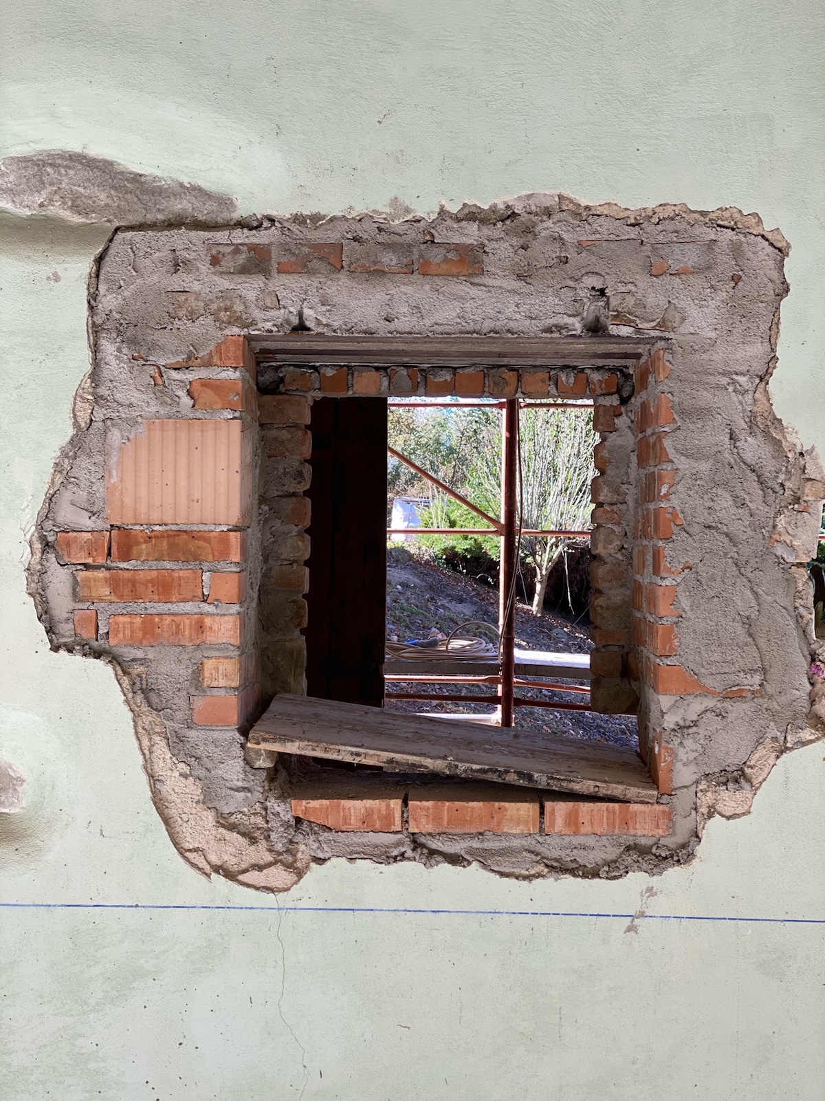 Detailing of an historic restoration of a window with exposed red brick | Vocabolo Moscatelli: A 12th-Century Monastery Reborn as a Boutique Design Hotel in Umbria