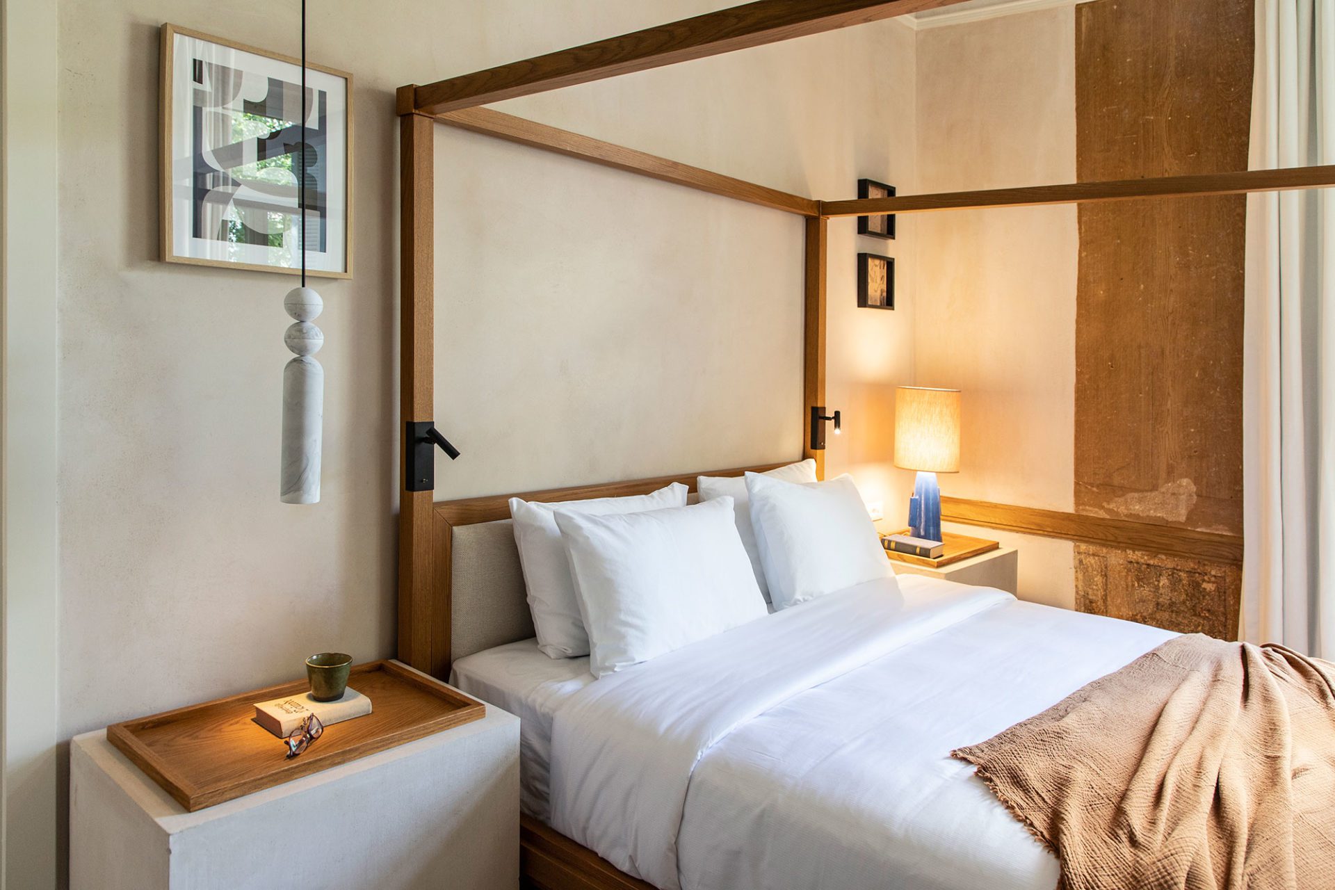 Oak four-poster bed and marble pendant light in a bedroom at Monsieur Didot, Kolonaki | The Aficionados