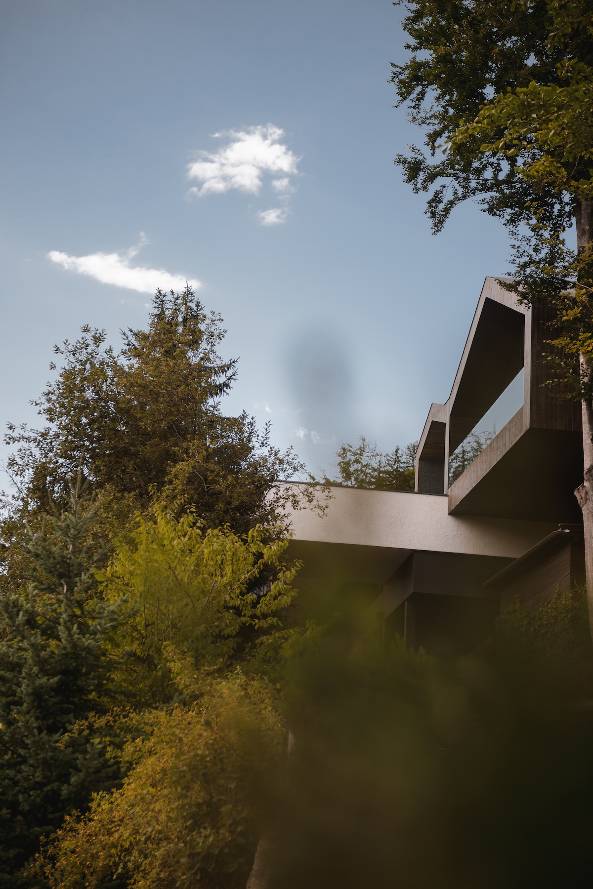 External architecture of wooden hits clingin got the mountains | MIRAMONTI Hotel South Tyrol | Boutique Alpine Retreat Above Merano