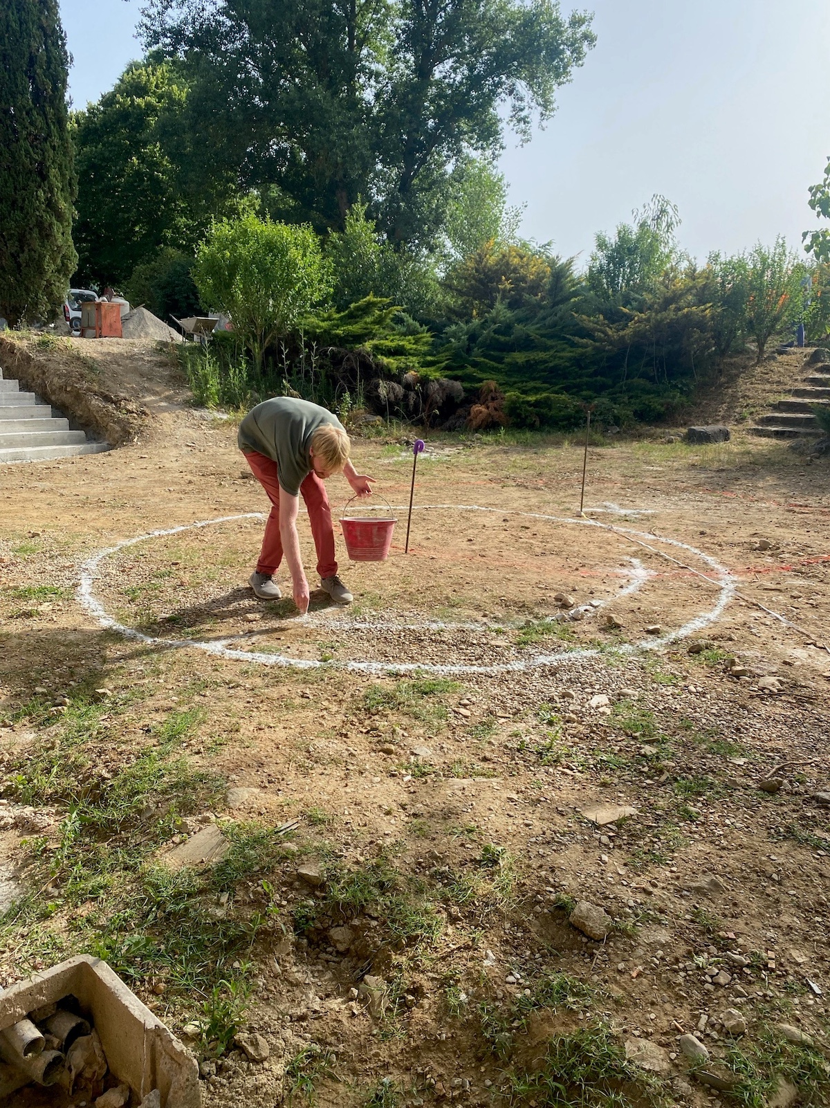 Man mapping out the landscaping using chalk to mark the boundaries and planting |Vocabolo Moscatelli: A 12th-Century Monastery Reborn as a Boutique Design Hotel in Umbria