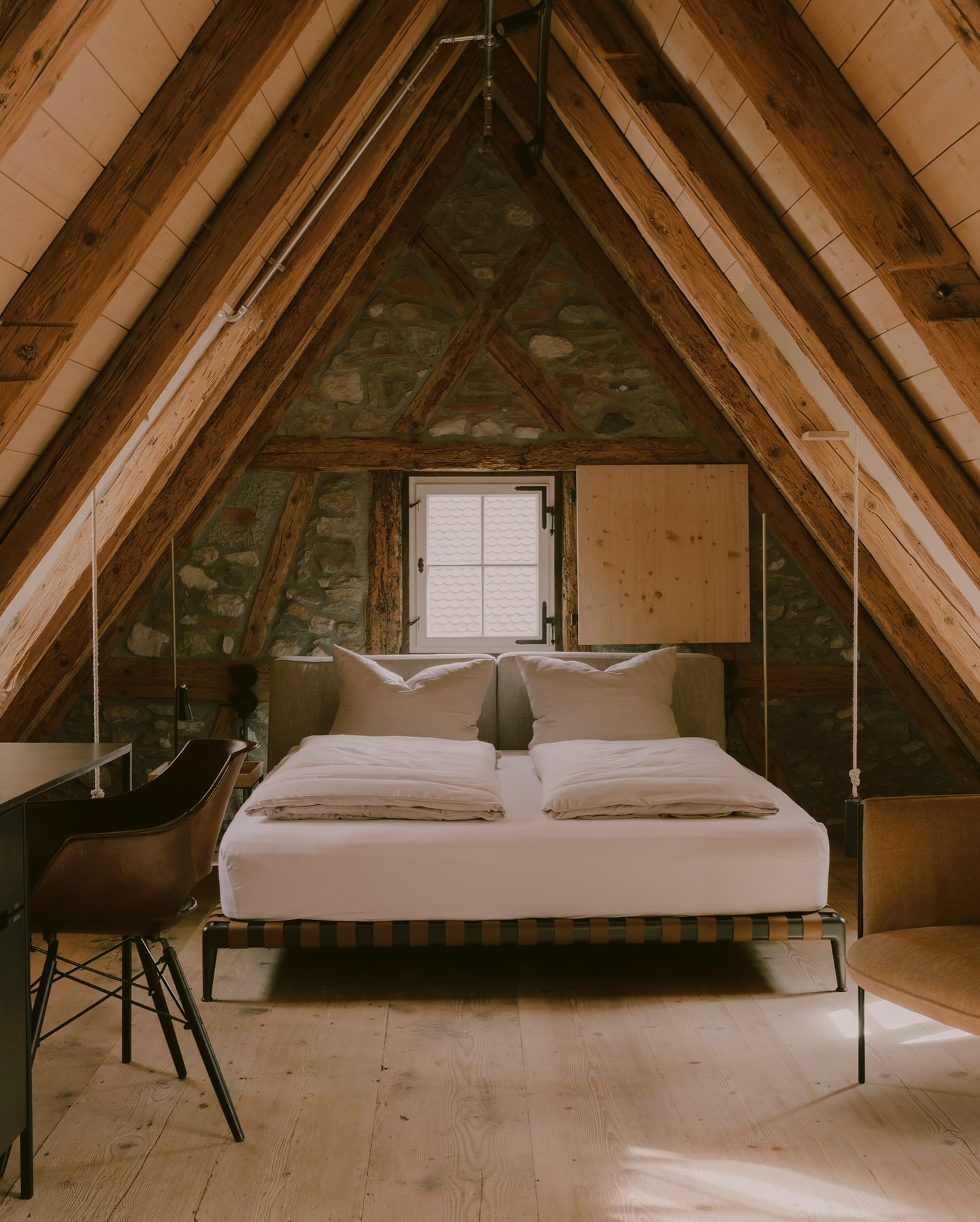 Hotel Krone Germany Historic Hotels Bed with a pitched timber roof and original historic stonewall | Poetic Design Hotels & Creative Hideaways Across Europe – The Aficionados