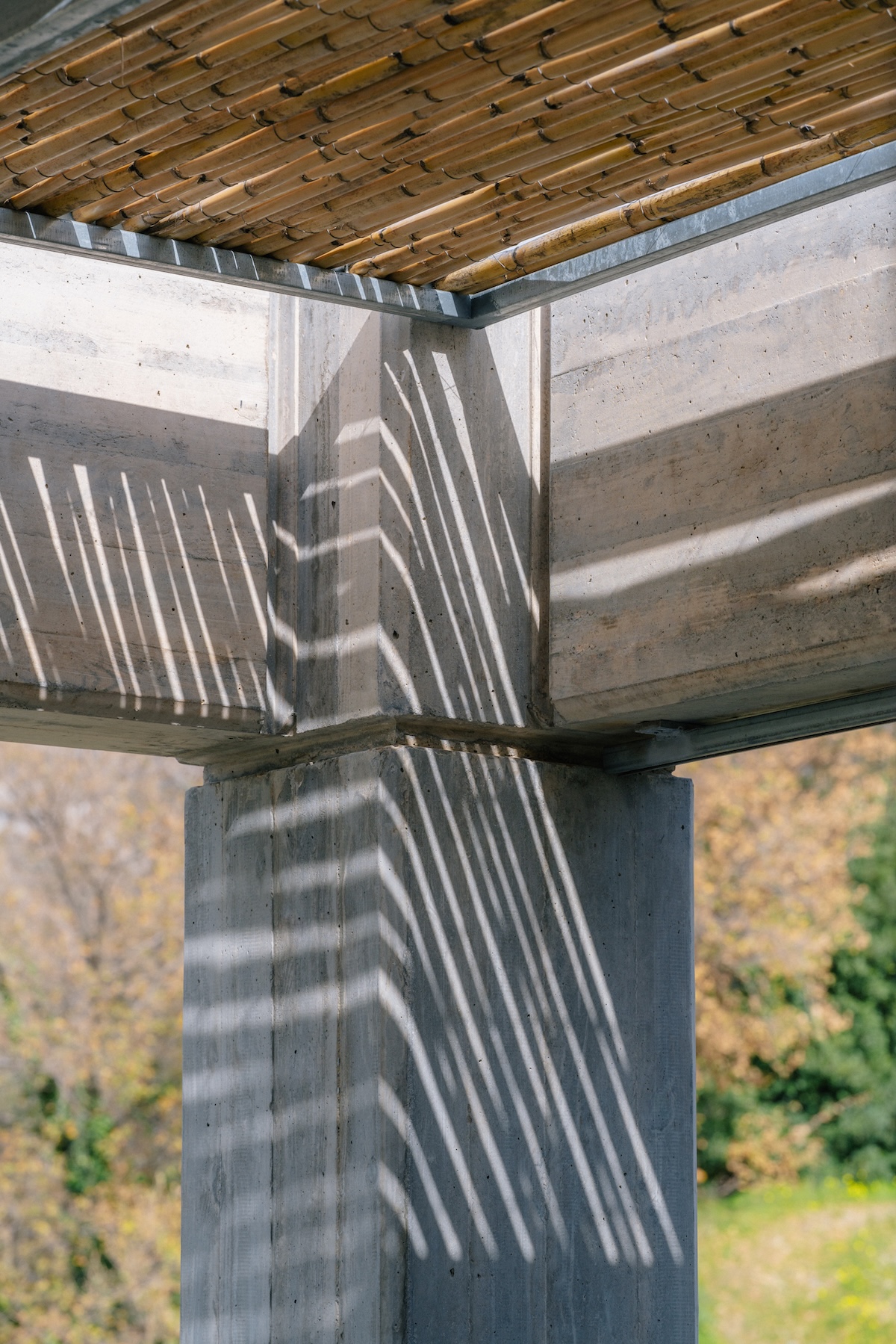 Board-marked concrete beams and a bamboo pergola casting striped shadows at Meraki Studios, Crete | The Aficionados
