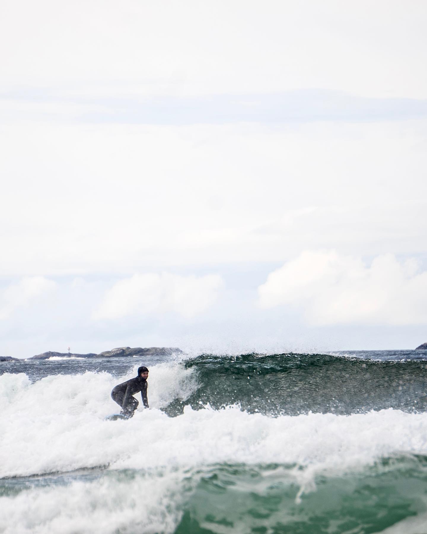 Person riding the waves | Surfing | Wild beaches of Norway - Mountains, clear arctic waters and wilderness of Lofoten | The Aficionados 