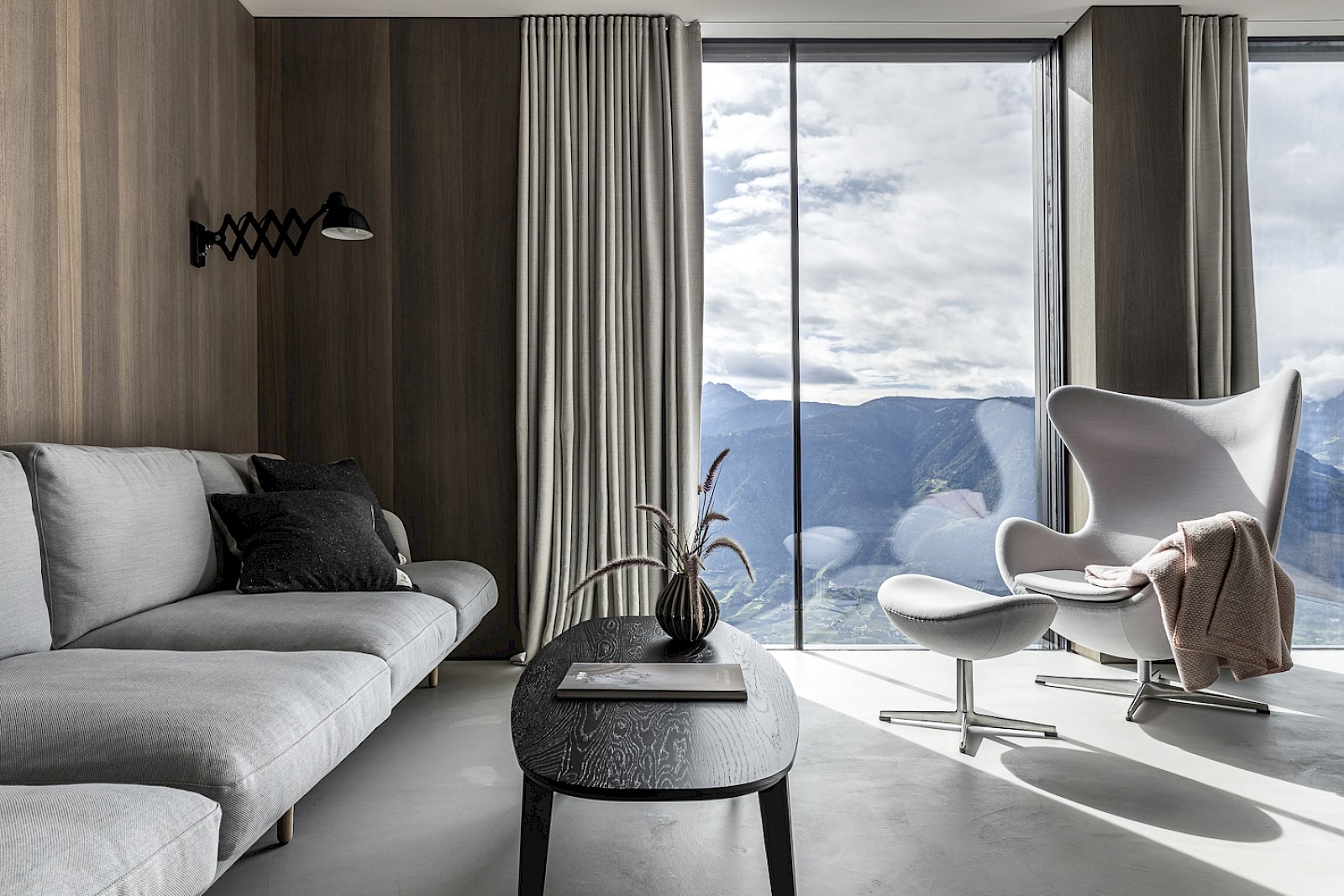 Scanidanvian Alpine living. - interiors in light grey with mountain views | MIRAMONTI Hotel South Tyrol | Boutique Alpine Retreat Above Merano