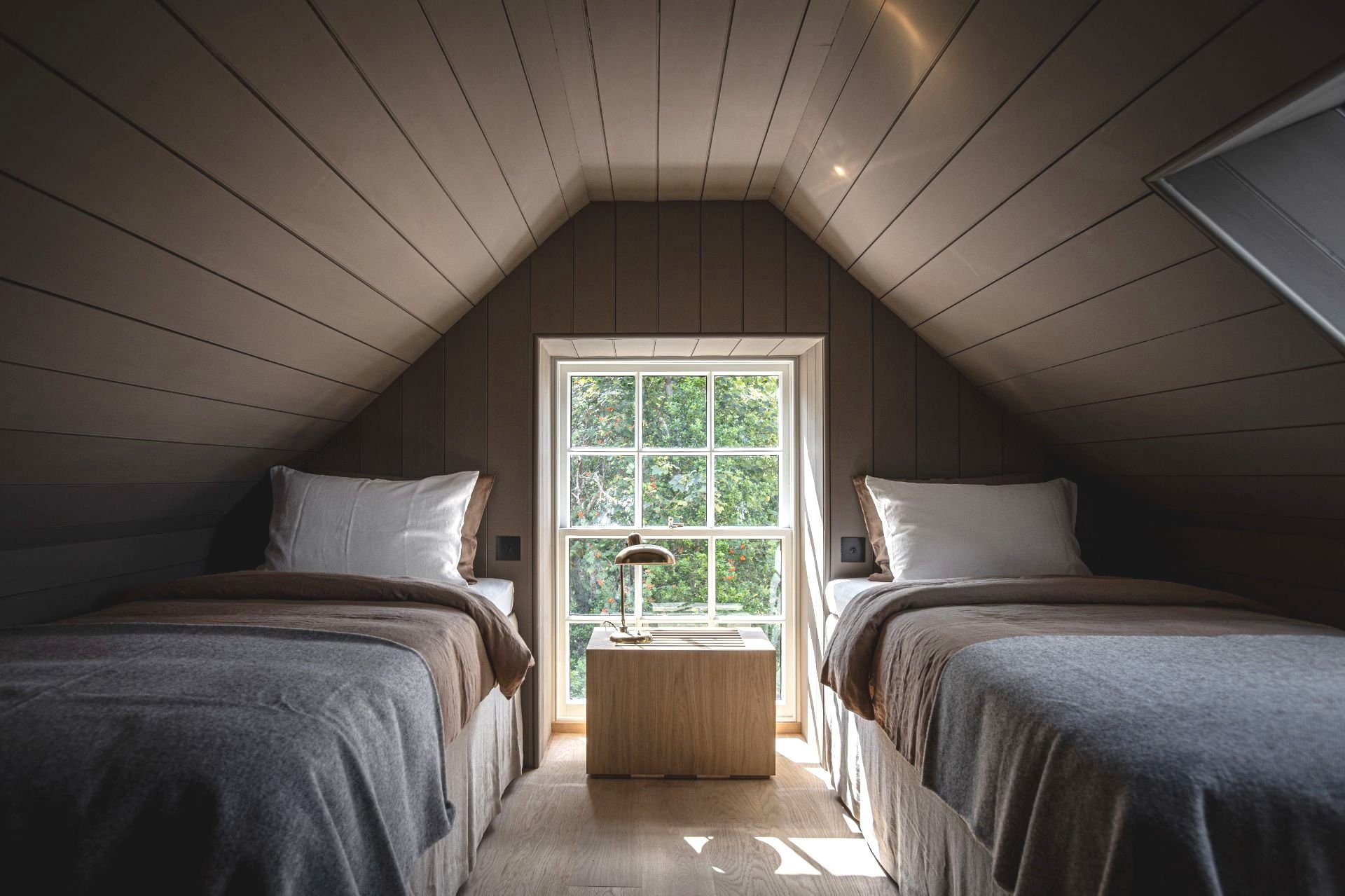 Fabulous Bedroom Interior design decorated in bicuit tones, two single beds in the eaves fo the Hotel Lundies Scotland |Ruth Kramer: Interior Designer Behind Brücke 49 & Wildland