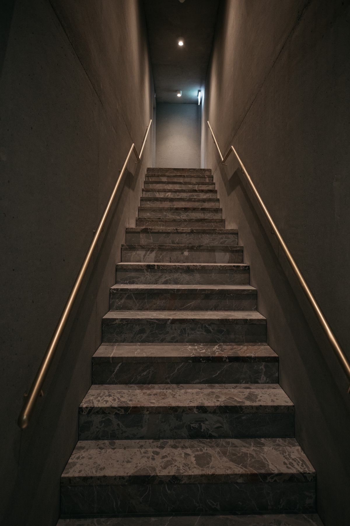 Darkend stairwell leading to the spa sanctuary of the hotel, Stone, Steam and Stillness: Inside the Spa Sanctuary at Maistra 160