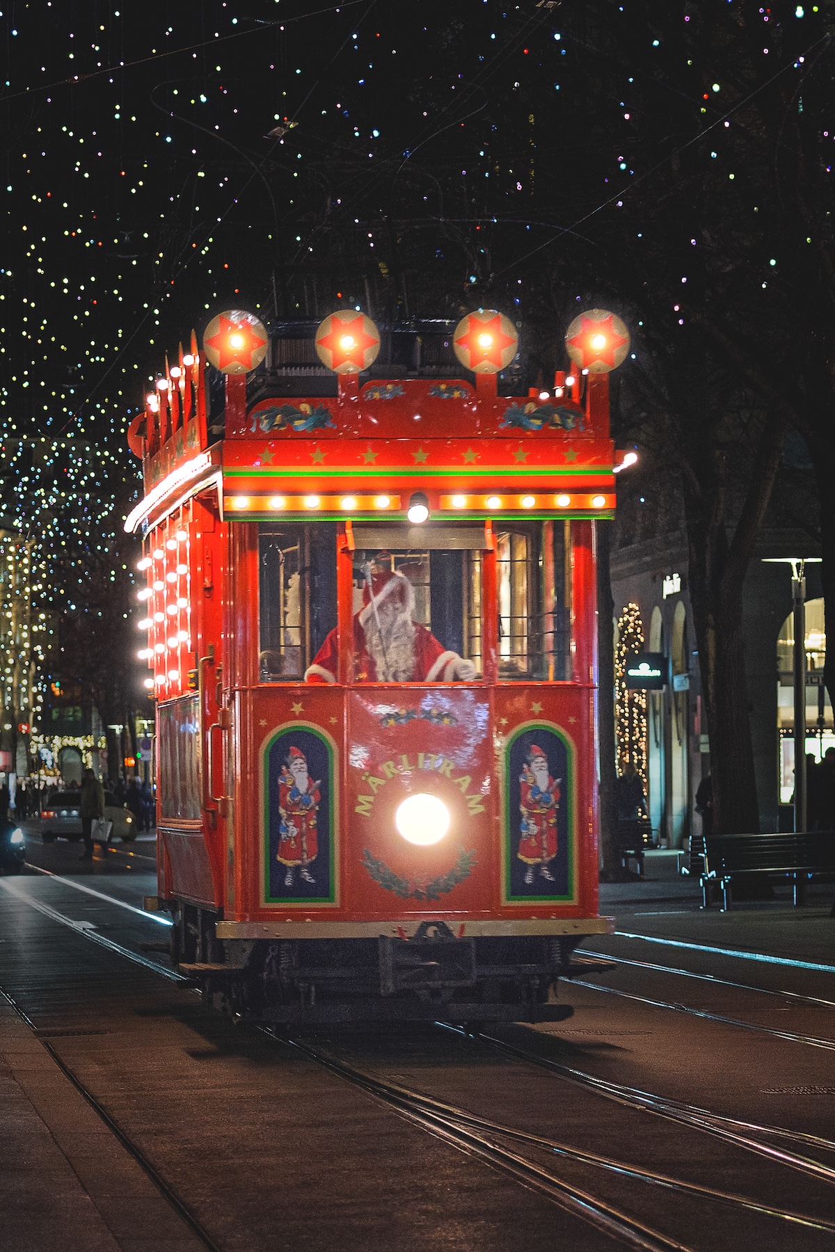 A red, festive Christmas train carrying children around the city and to Santa in Zurich, Switzerland