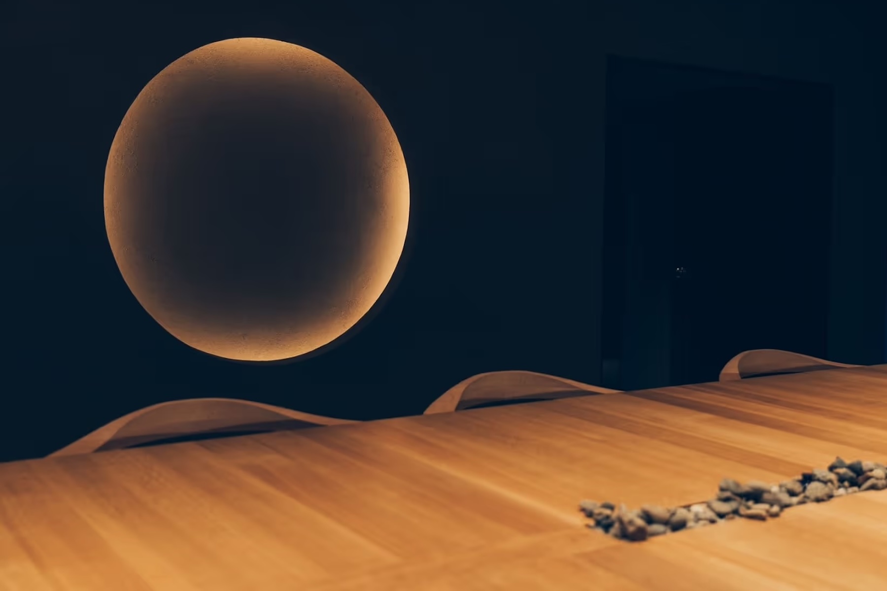 A glowing circular earthen niche above the dining table at Auberge Né, with river stones set into the timber | The Aficionados