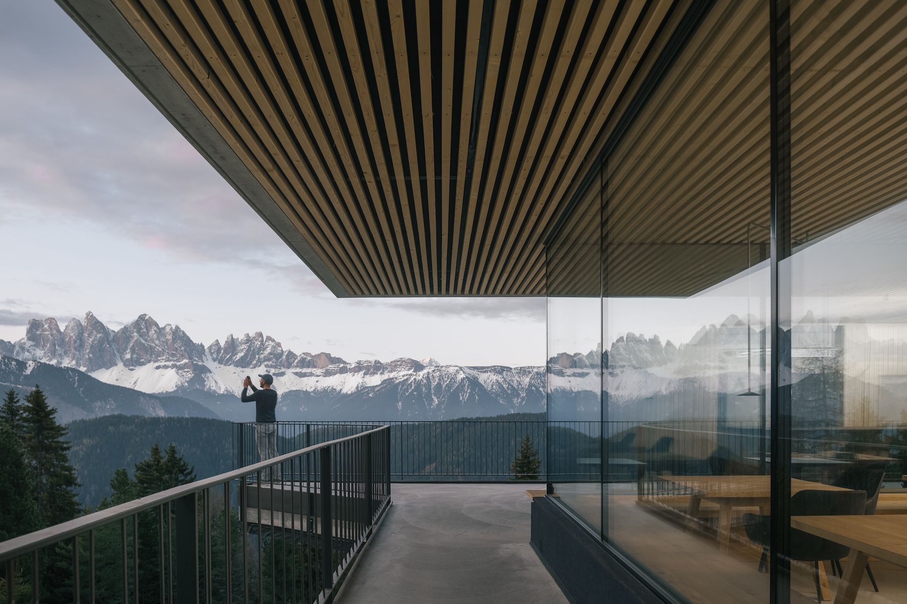 Anders terrace, hero Slatted timber soffit and full-height glazing framing the Odle peaks at dusk, Anders Mountain Suites by Martin Gruber | Wildlings | The Aficionados