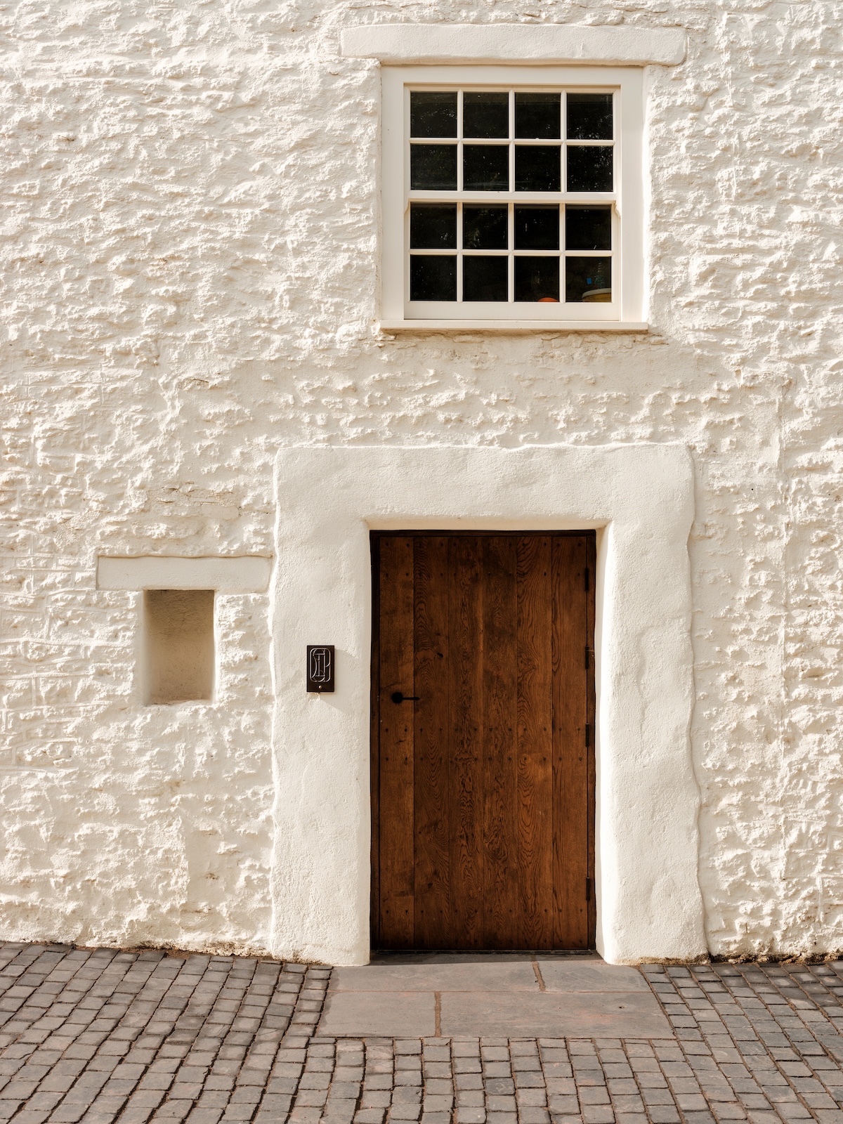 Red door white fascade traditional white walls and sash window |