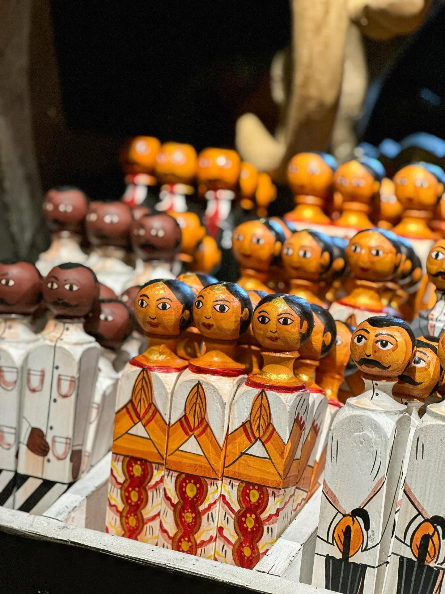 Rows of brightly painted wooden folk figures for sale at Barefoot, Colombo