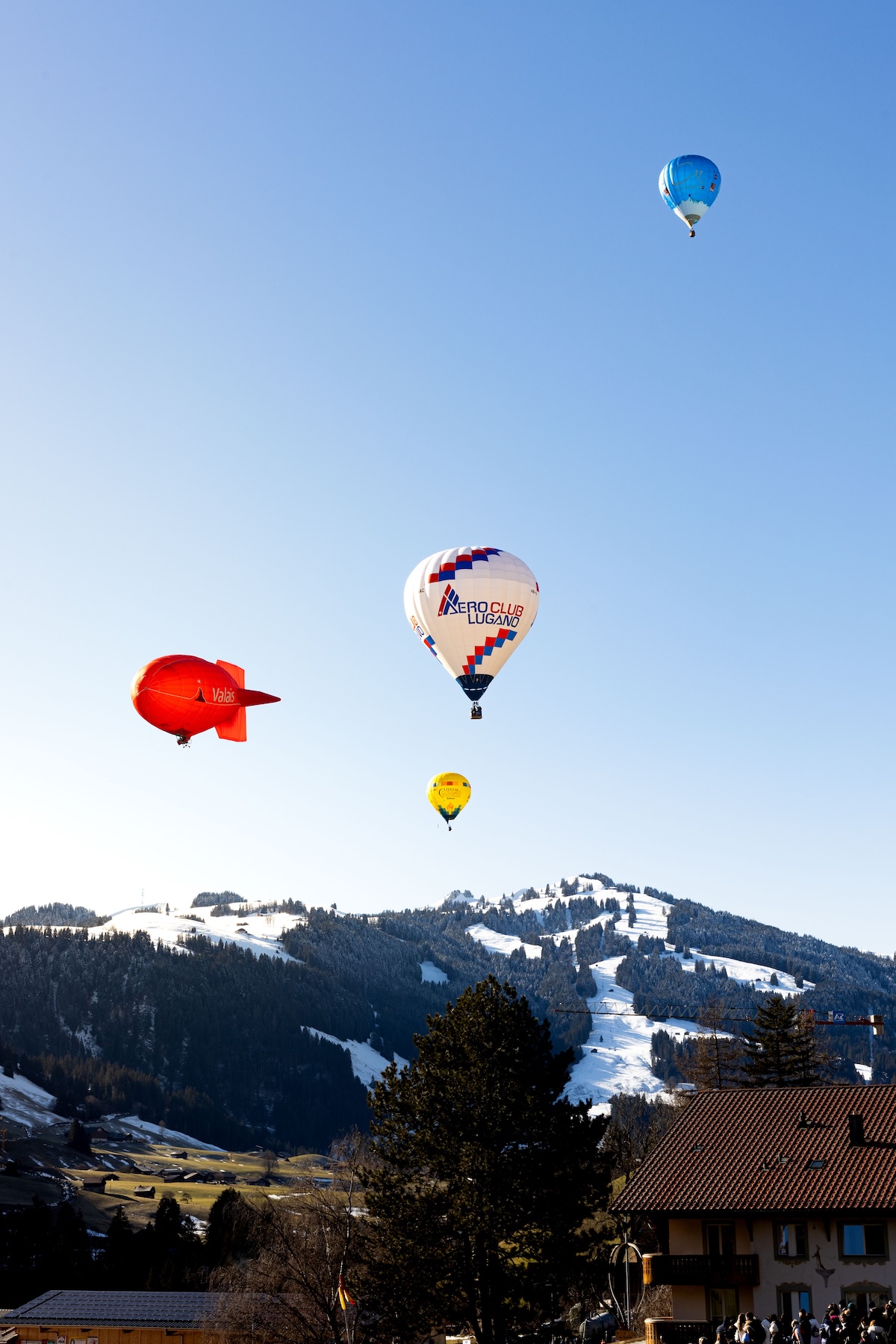 A photo of a number of colourful hot air balloons before a blue sky