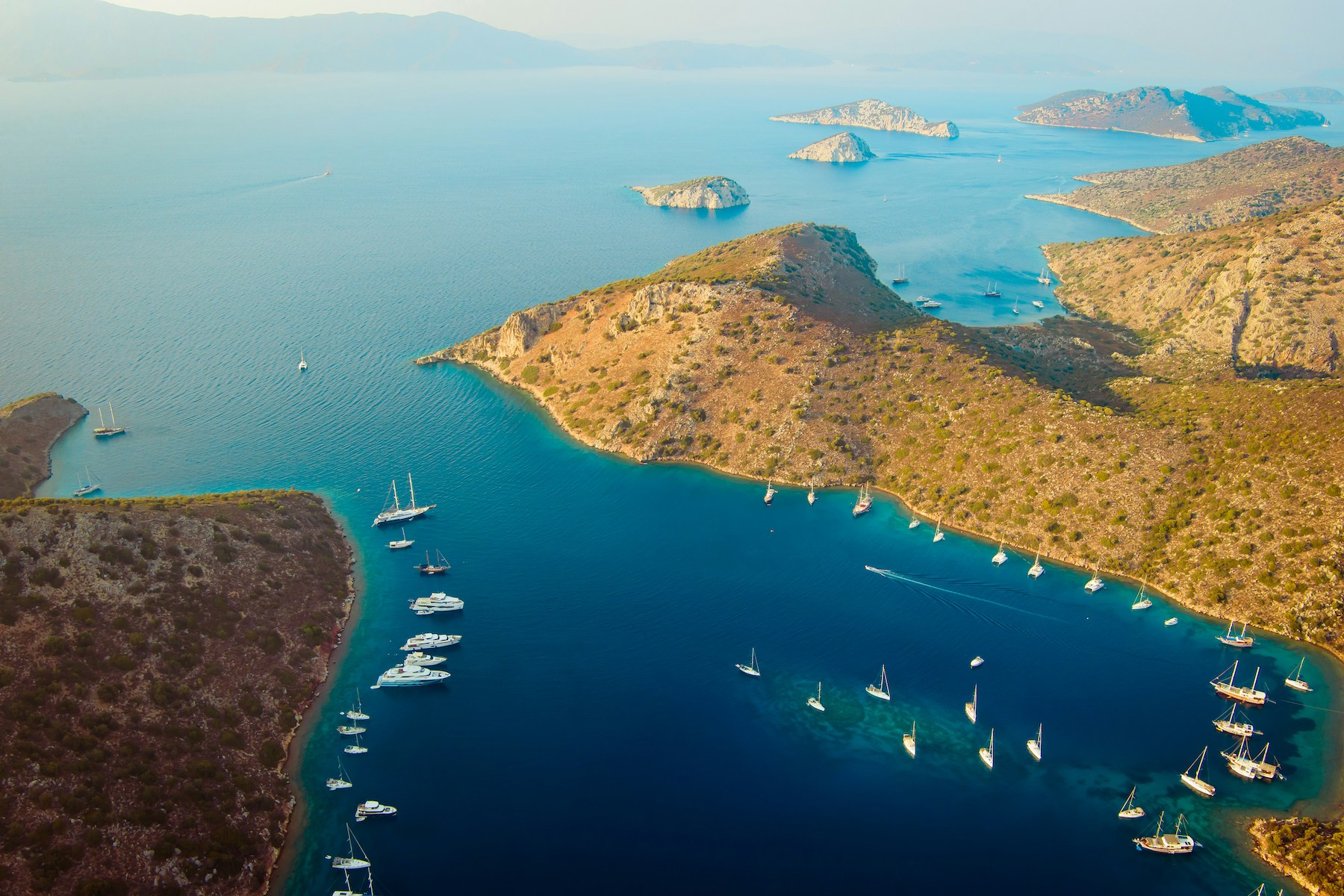 Aerial Image over Türkiye's Riviera featuring yachts in the blue sea, summer in the Mediterranean |Untamed Beauty of Türkiye’s Riviera: A Journey Through Ancient Bays and Forested Shores