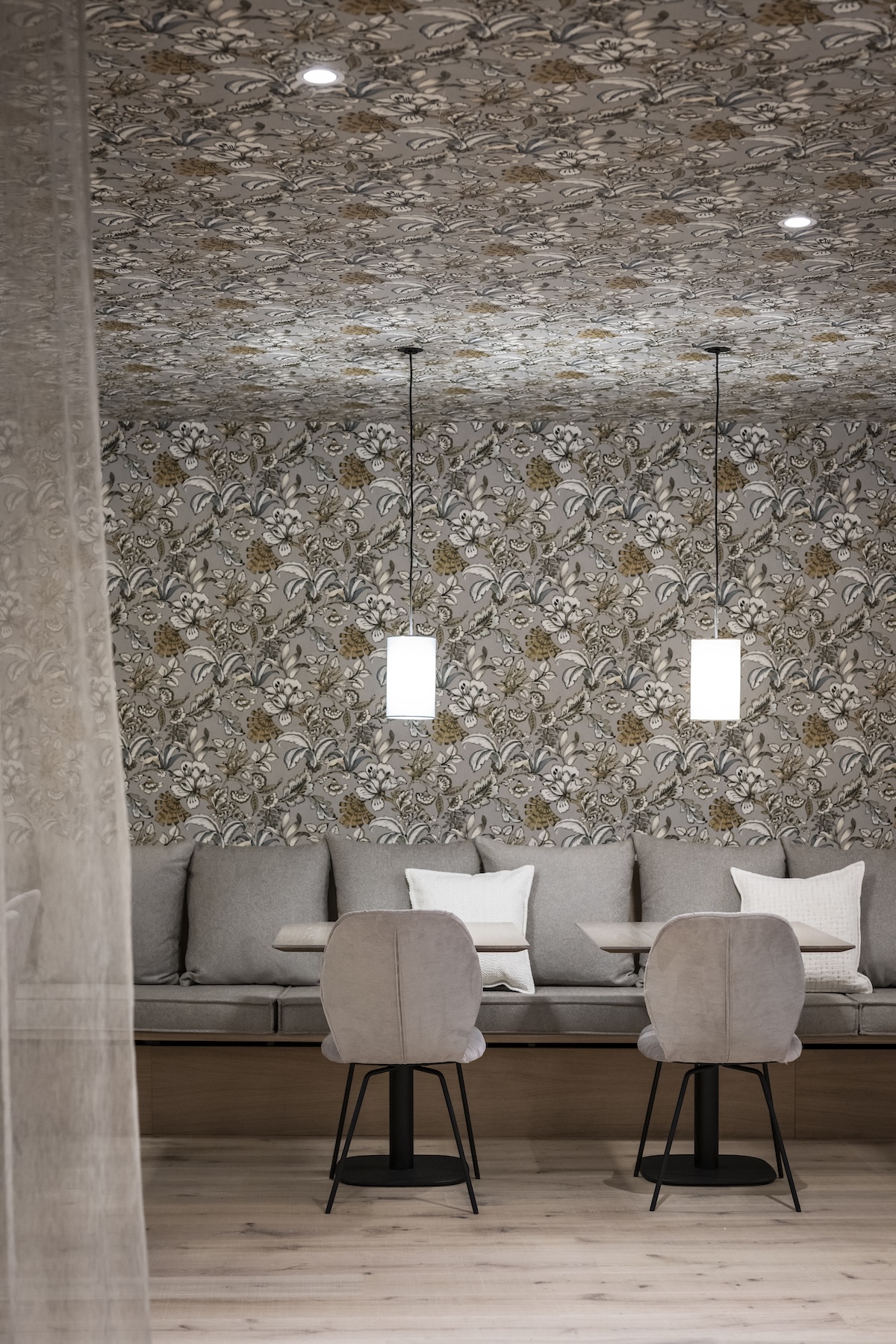 Banquette seating and pendant lighting against botanical wallpaper in the Kantine Rosine restaurant, Hotel Goldene Rose Dinkelsbühl | The Aficionados