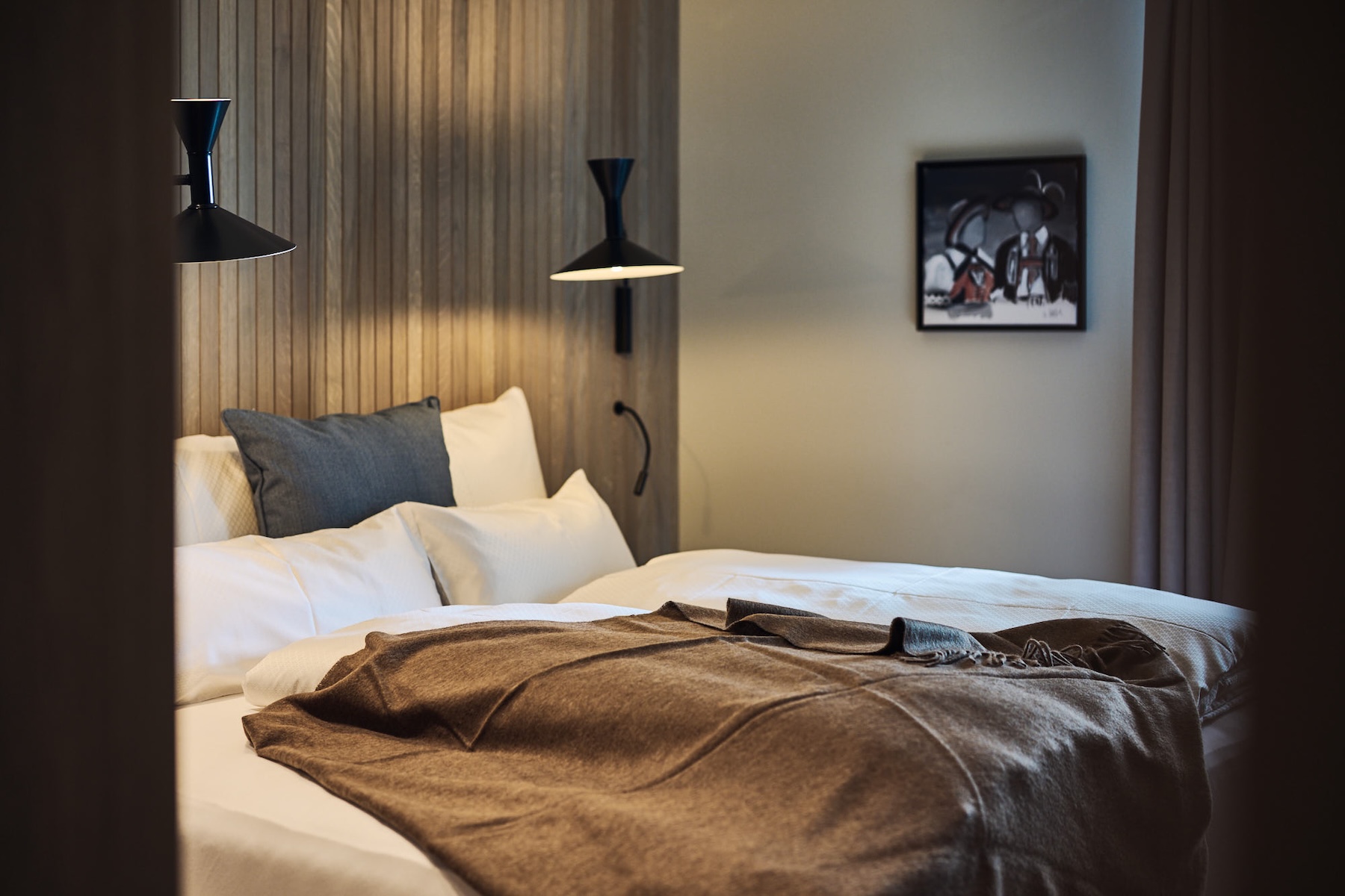 Design room at Ullrhaus St. Anton with timber-slatted headboard and muted Alpine interiors by Stephanie Thatenhorst | The Aficionados
