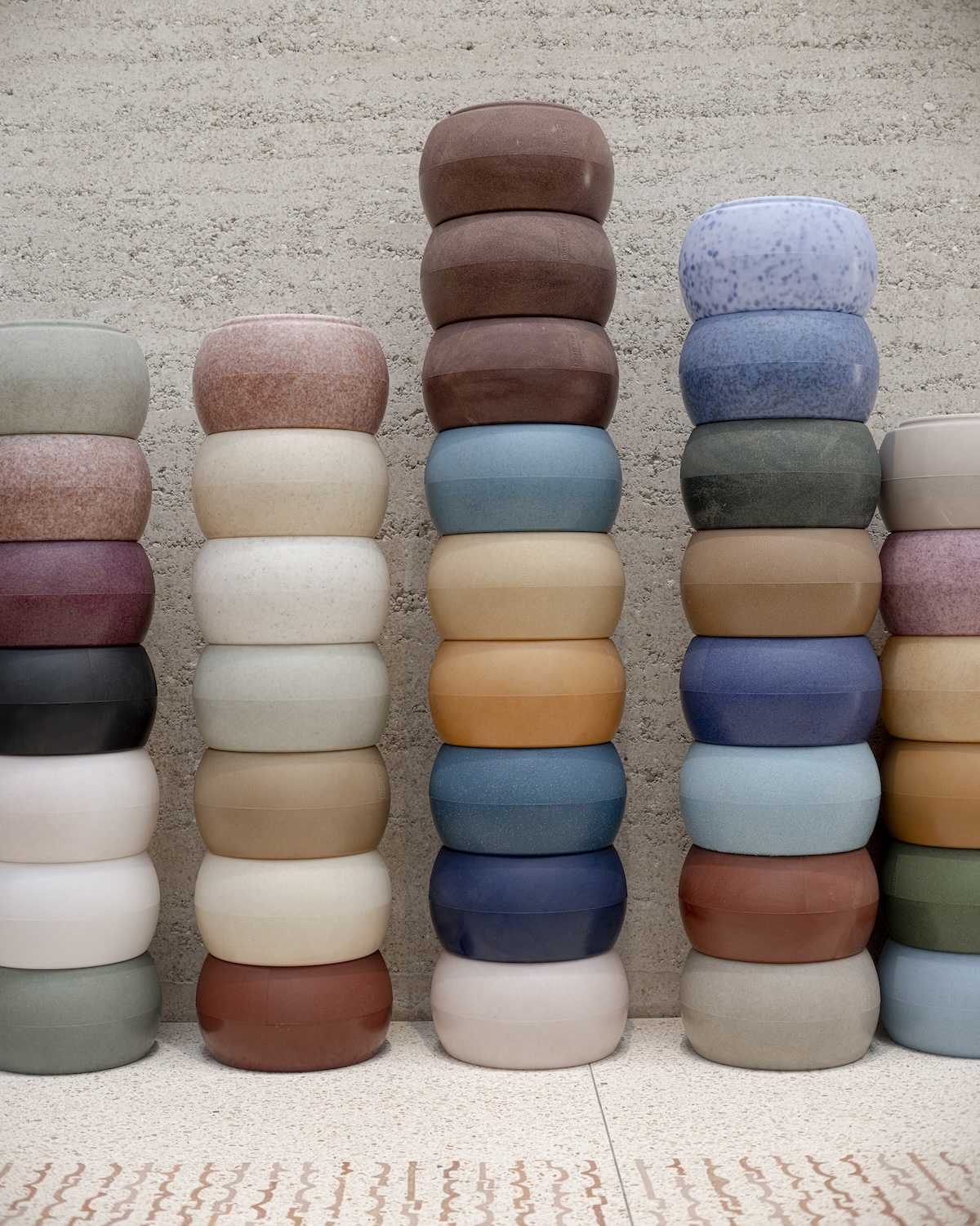 Stacked discs of pigmented material in muted blues, greens and earth tones forming a colour archive at Atelier LUMA, Arles | The Aficionados