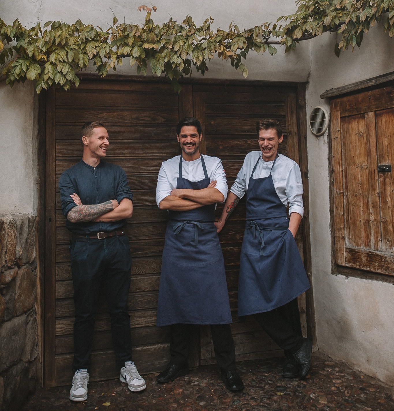 Chef-patron Christoph Huber, centre, with sous chef Stefan Vorhauser and a member of the brigade outside the back door of Wirtshaus zur Blauen Traube, Algund | TheAficionados.com
