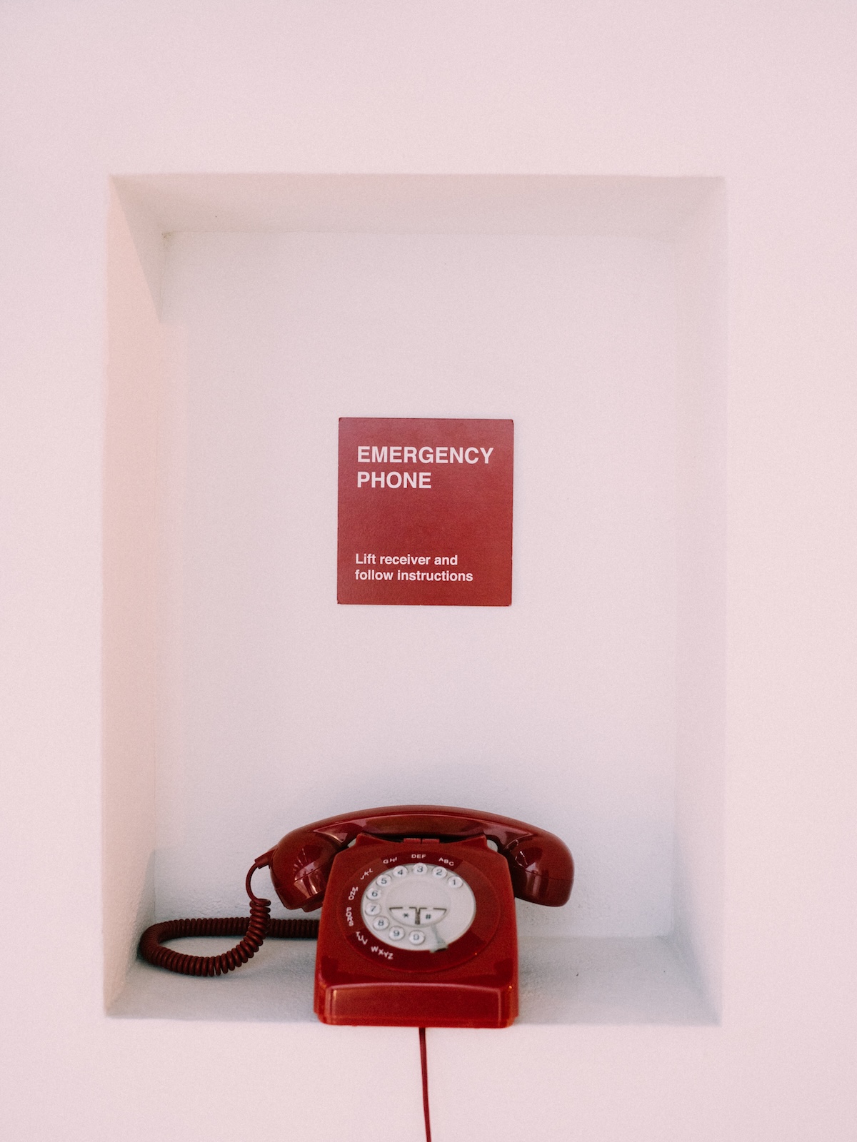 Tim Etchells' red Emergency Phone in a wall niche at Arthotel Blaue Gans, Salzburg | The Aficionados