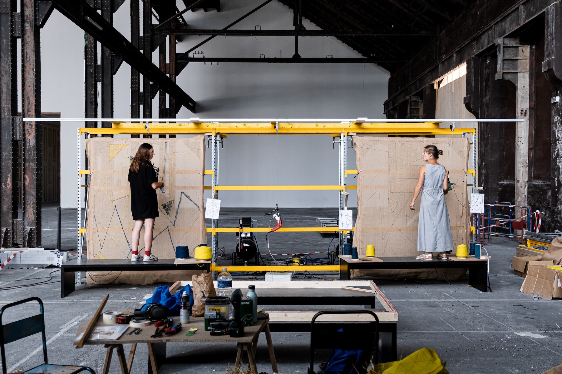 Two designers working on a mobile prototyping rig inside Atelier LUMA's industrial workshop, surrounded by tools and materials | The Aficionados