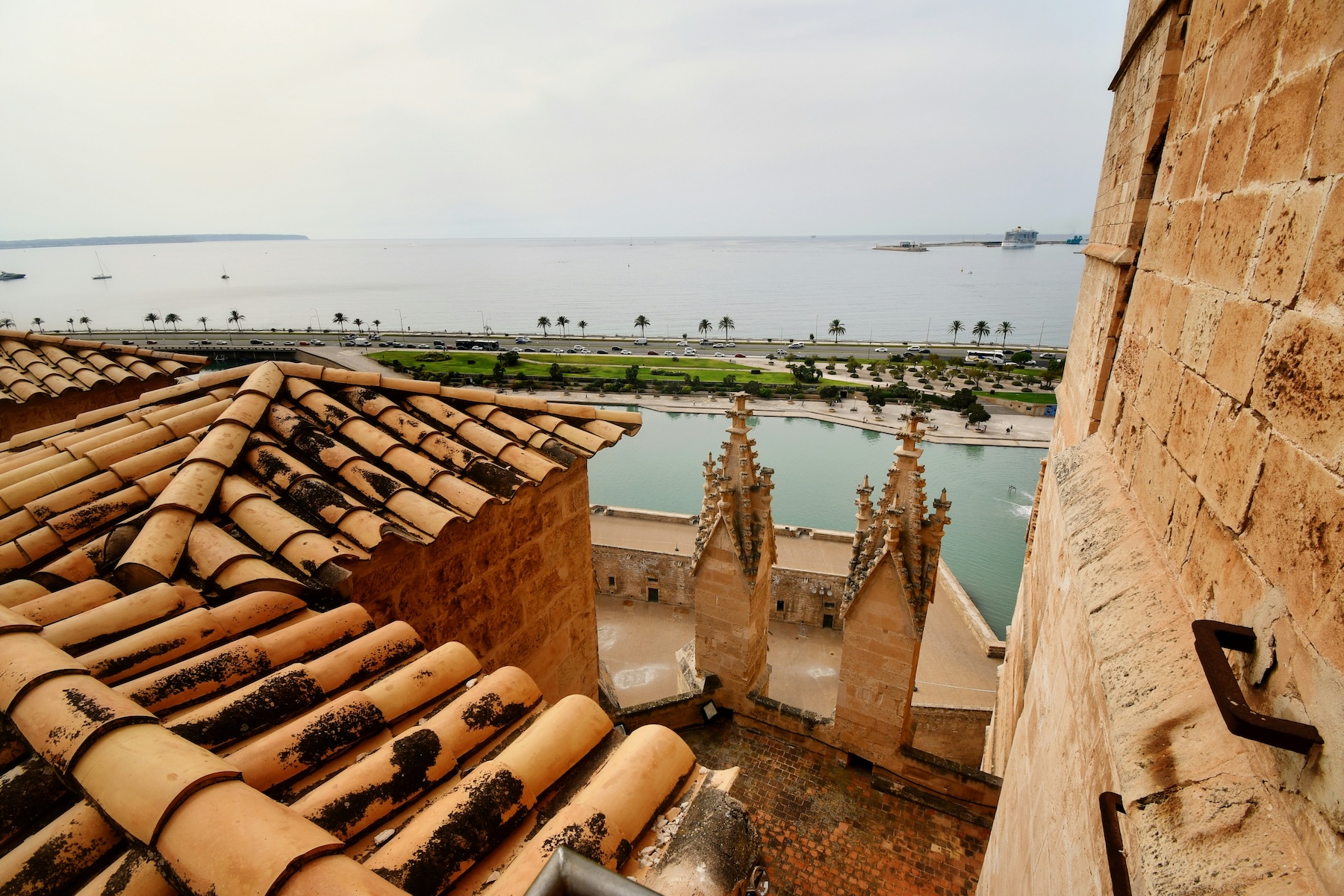 Looking down from the roof terraces of La Seu over pantiles and carved pinnacles to the Bay of Palma | The Aficionados