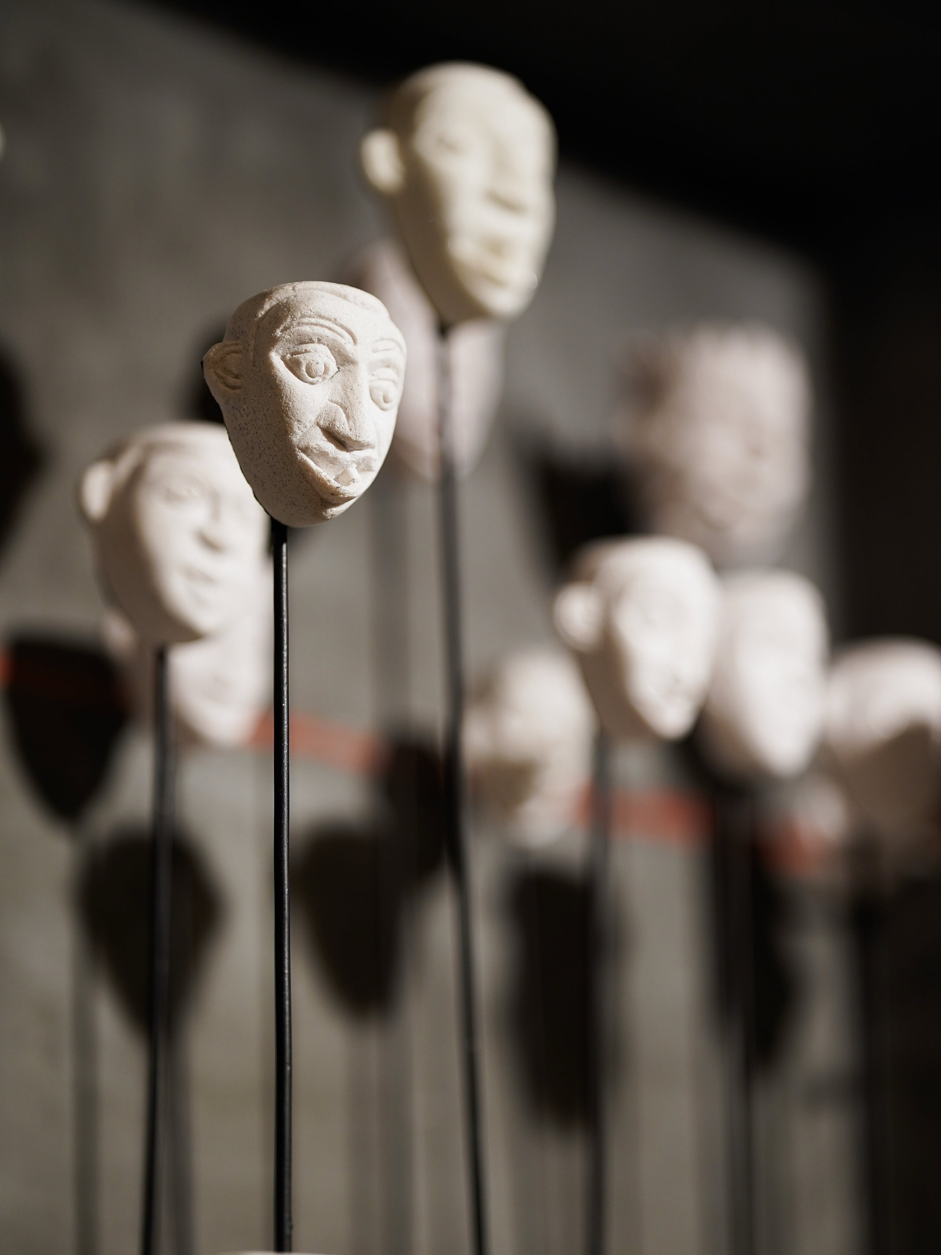 Hand-sculpted ceramic heads displayed on slender rods at Paradise Road, Colombo's lifestyle and design store
