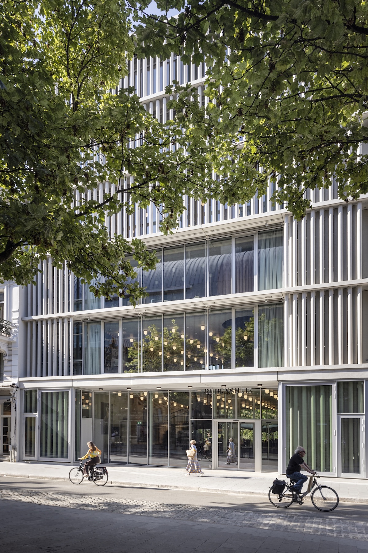 New Rubenshuis visitor building on Hopland with passing cyclists, Antwerp | The Aficionados