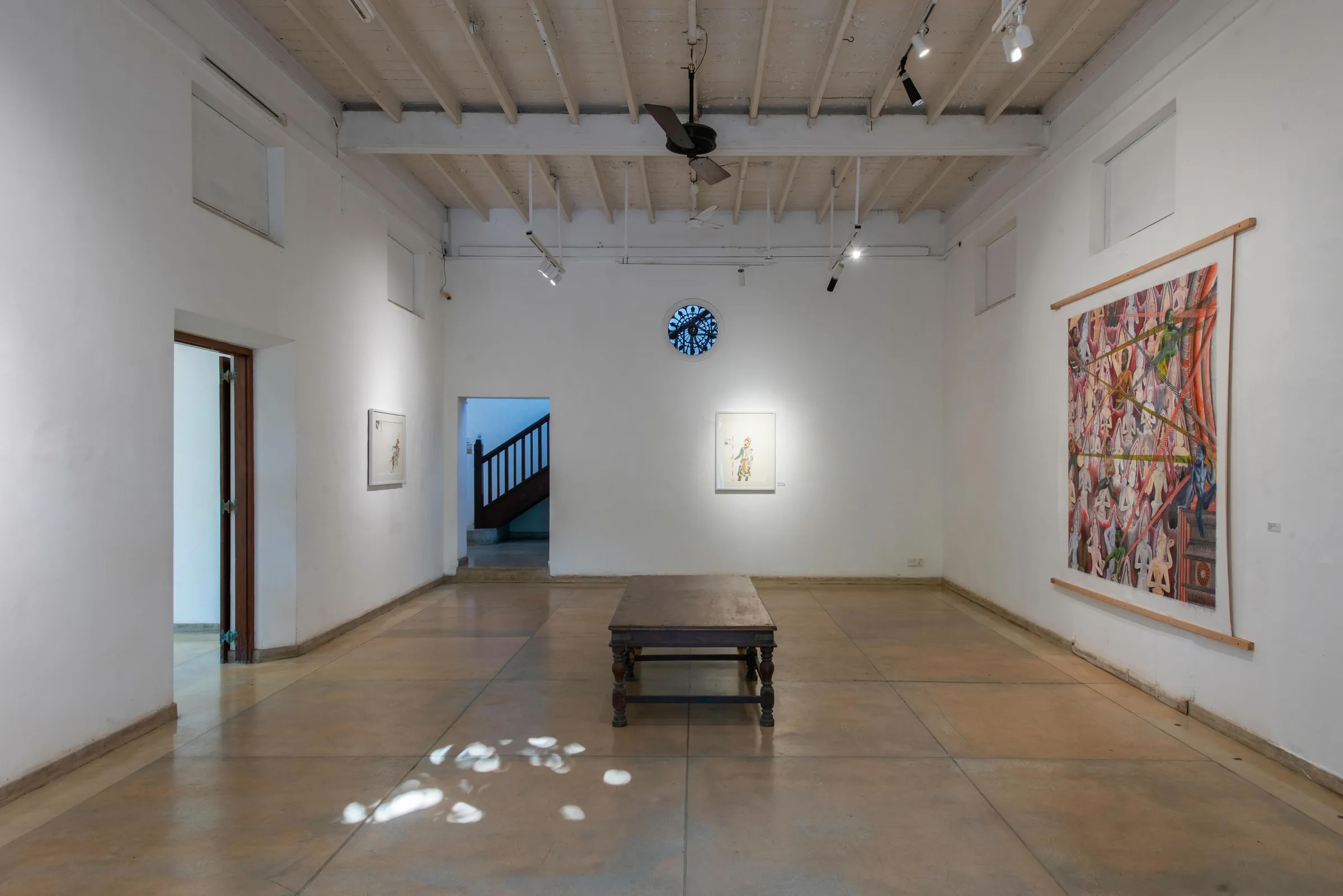 Whitewashed gallery room hung with Sri Lankan paintings and polished concrete floor at the Sapumal Foundation, Colombo 7