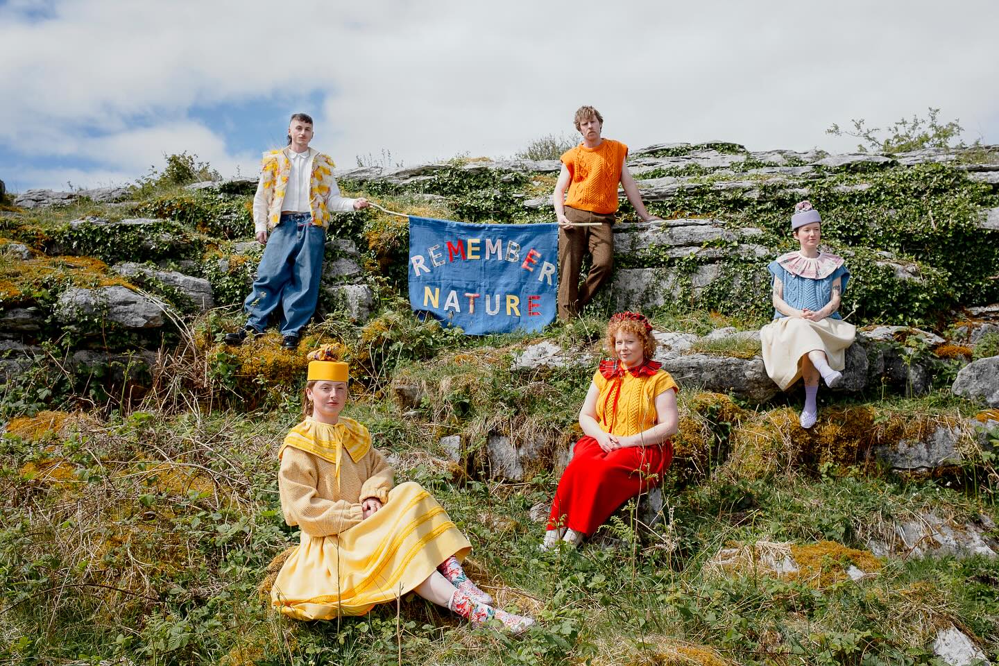 Five models on mossy Burren limestone around a hand-stitched blue 