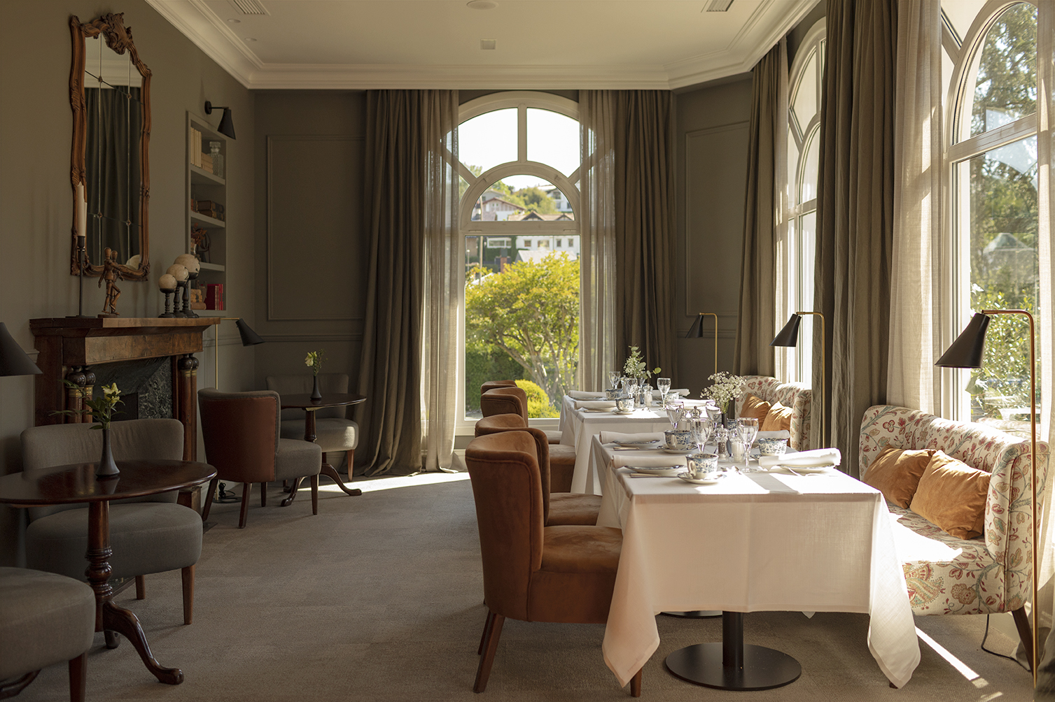 Breakfast room at Villa Soro with panelled walls, arched windows and floral banquettes, San Sebastián | The Aficionados