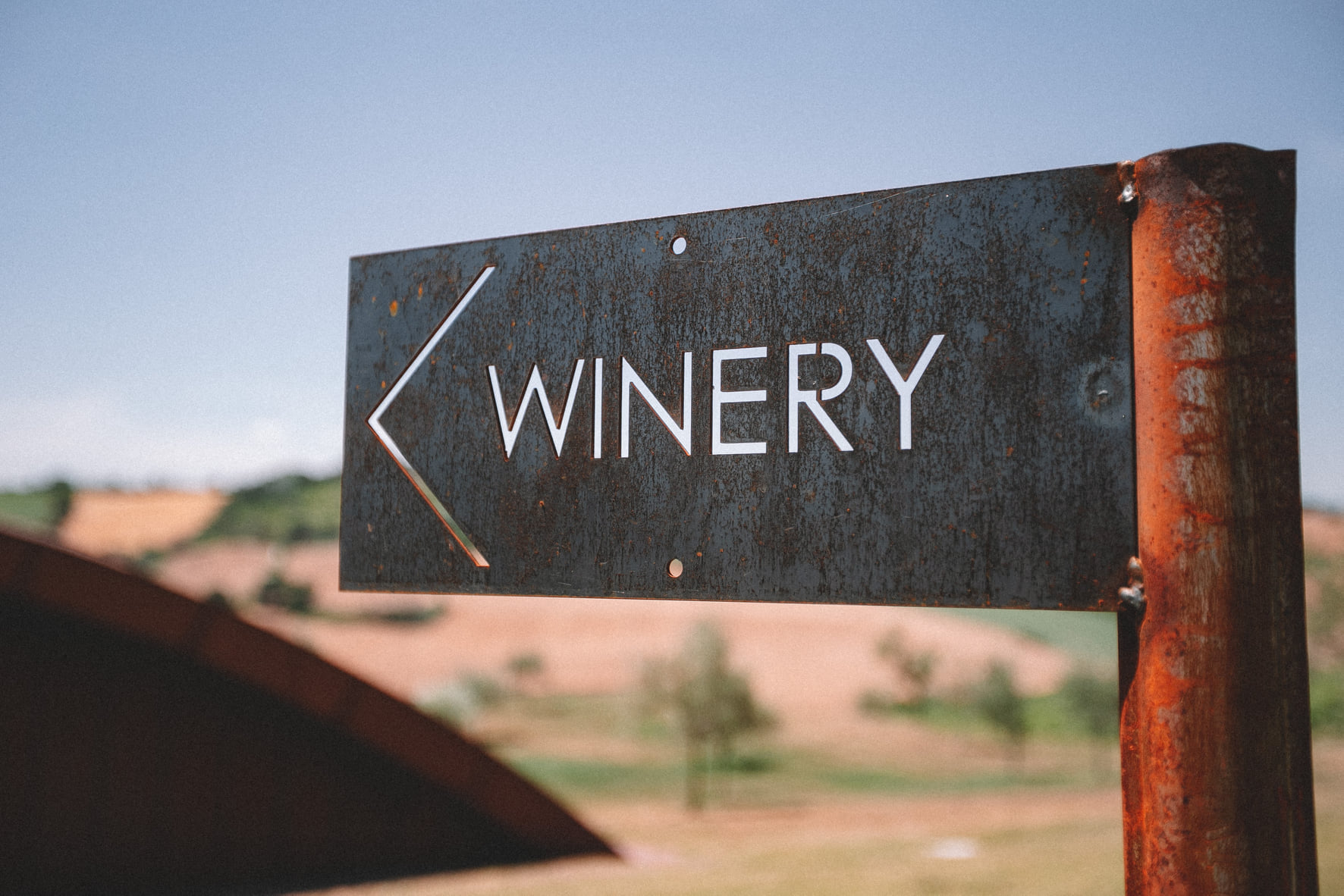 Rustic metal winery directional sign at Filodivino estate, Morro d'Alba, Le Marche Italy