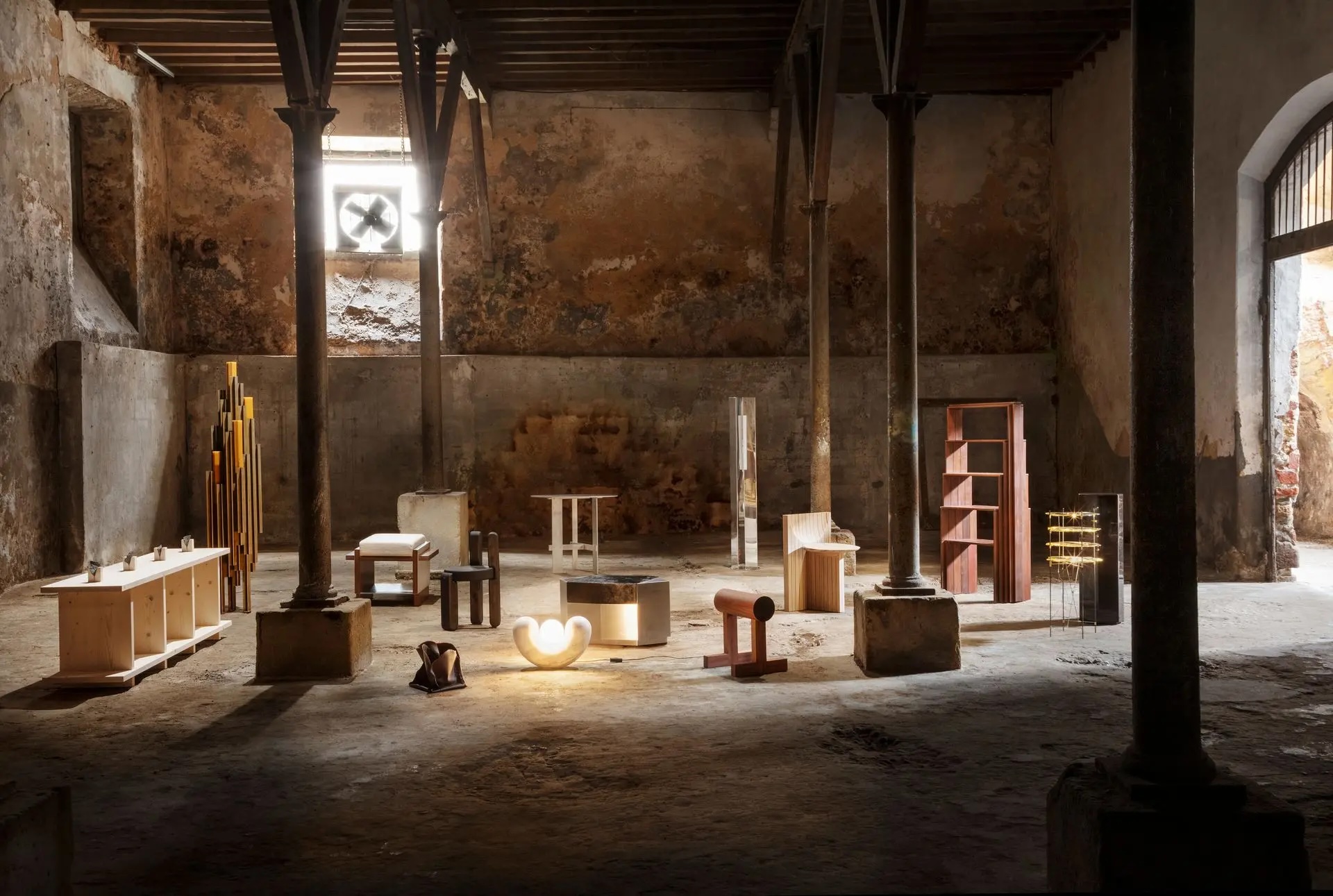 Design objects and handcrafted furniture displayed in a raw, aged stone interior at Lisbon Design Week 2026
