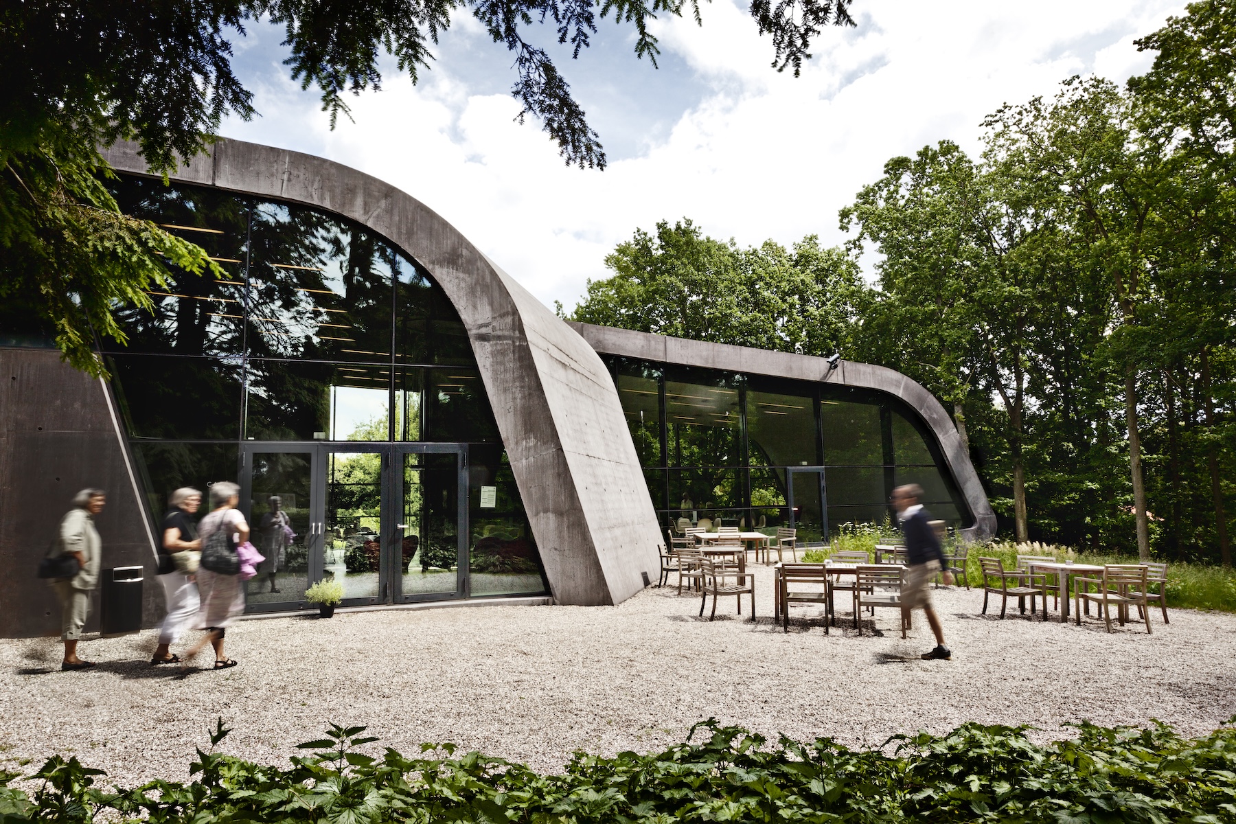 Visitors outside the curved concrete-and-glass Zaha Hadid extension at Ordrupgaard museum in Gentofte.